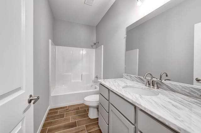 bathroom with toilet, visible vents, vanity,  shower combination, and wood tiled floor