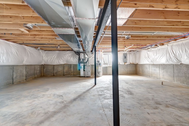 unfinished basement with gas water heater, electric panel, and heating unit