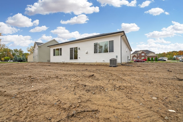 back of property featuring central AC