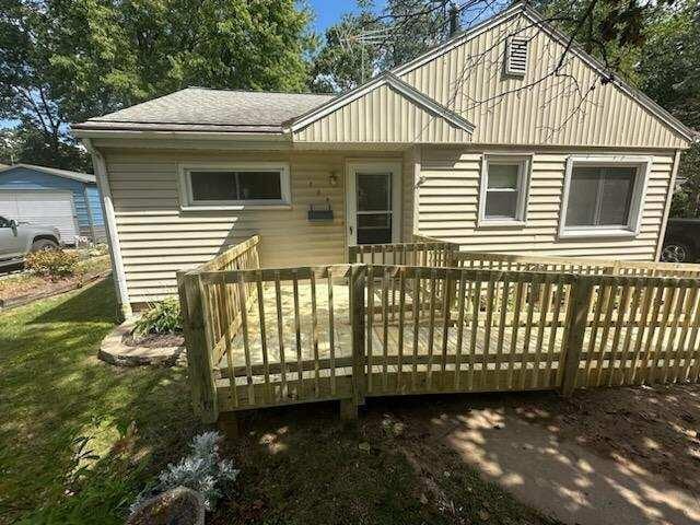 back of house with a wooden deck