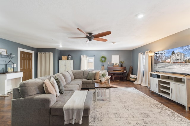 living room featuring dark wood-style floors and ceiling fan