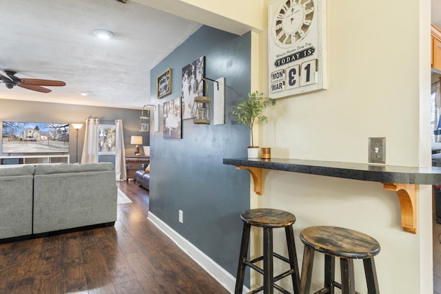 hallway with dark wood-style floors and baseboards