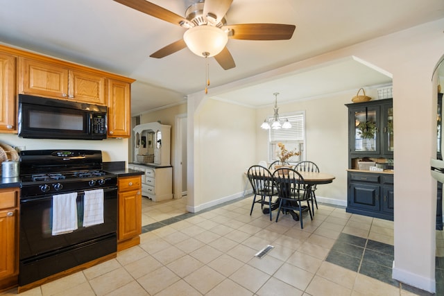 kitchen with dark countertops, brown cabinetry, glass insert cabinets, ornamental molding, and black appliances