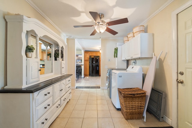 laundry room featuring crown molding, washing machine and clothes dryer, light tile patterned floors, cabinet space, and a ceiling fan