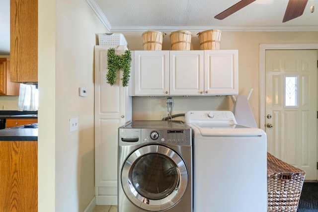 laundry room with cabinet space, ornamental molding, ceiling fan, a textured ceiling, and separate washer and dryer