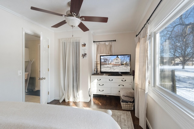 bedroom featuring dark wood-style floors, ornamental molding, and a ceiling fan