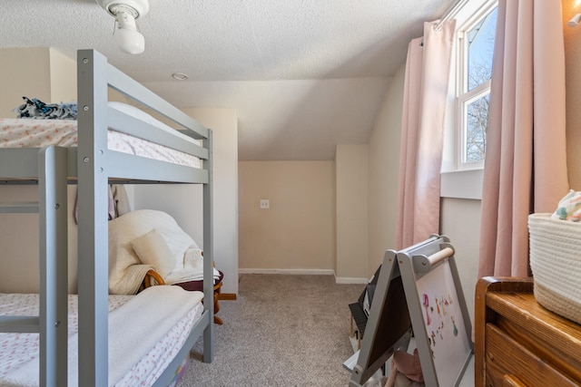 bedroom with carpet, vaulted ceiling, a textured ceiling, and baseboards