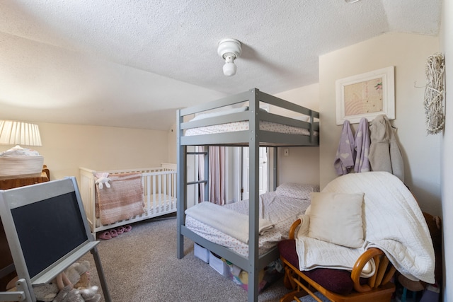 carpeted bedroom featuring lofted ceiling and a textured ceiling