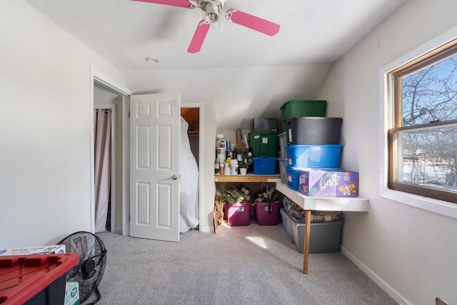 interior space featuring vaulted ceiling, ceiling fan, and baseboards