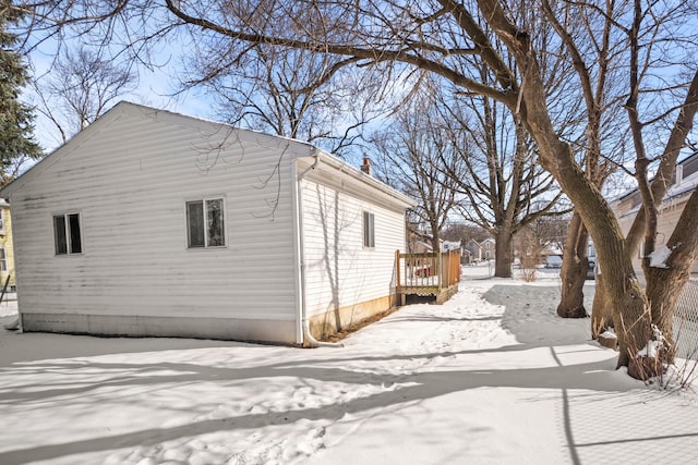 view of snowy exterior featuring a wooden deck