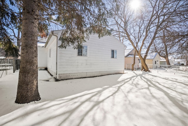 snow covered property featuring fence