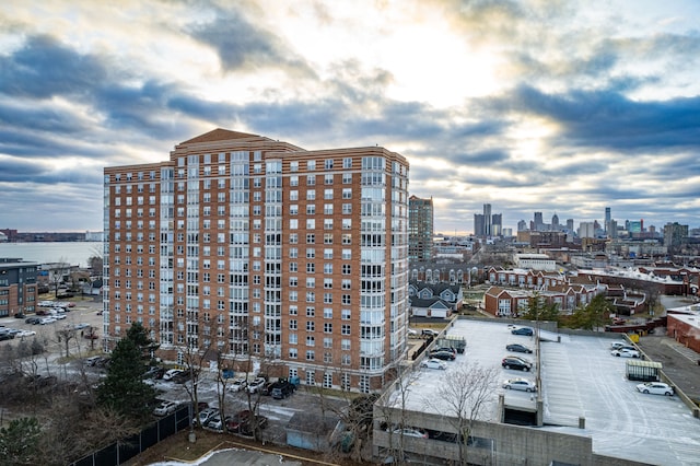 view of property featuring uncovered parking and a city view