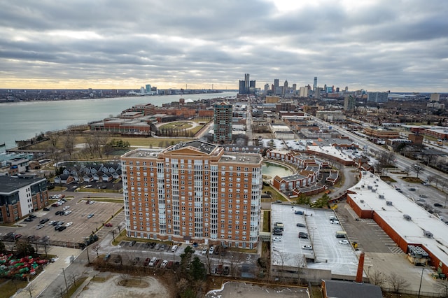 birds eye view of property with a water view and a city view