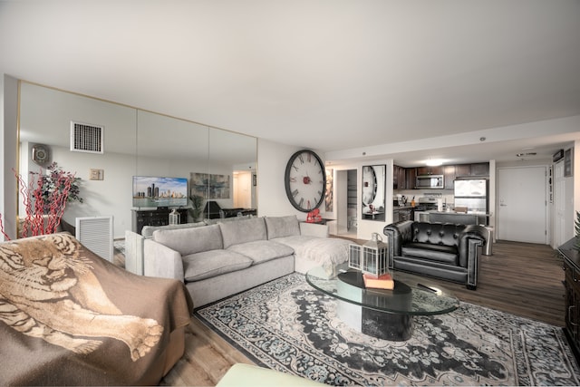 living room with visible vents and wood finished floors