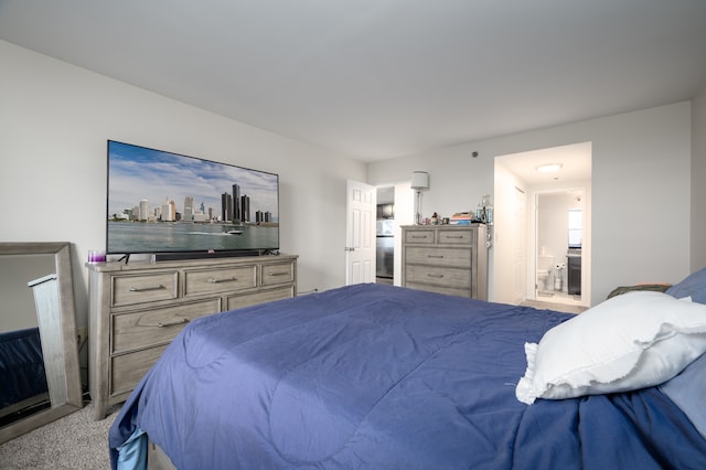 bedroom featuring light colored carpet and connected bathroom