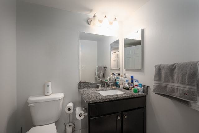 bathroom featuring toilet and vanity