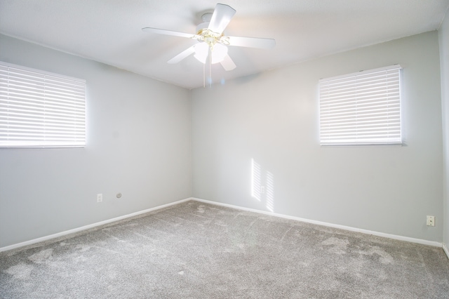 spare room featuring carpet flooring, a ceiling fan, and baseboards