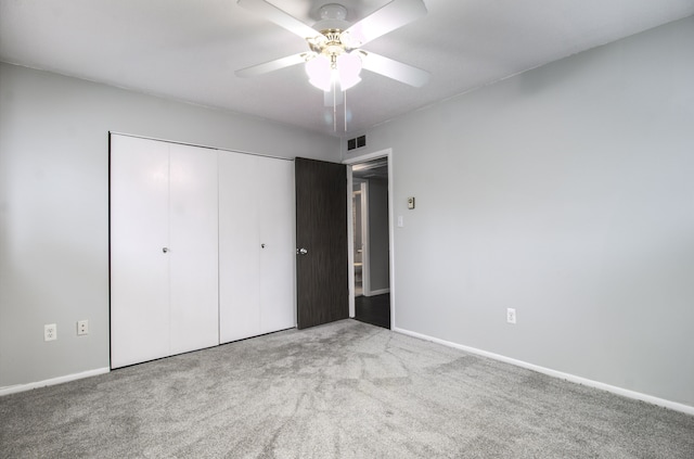 unfurnished bedroom featuring visible vents, baseboards, a ceiling fan, carpet, and a closet