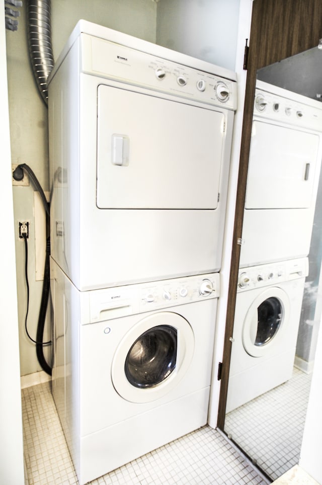 washroom with laundry area, tile patterned floors, and stacked washer / drying machine