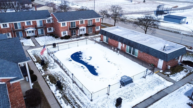 snowy aerial view with a residential view