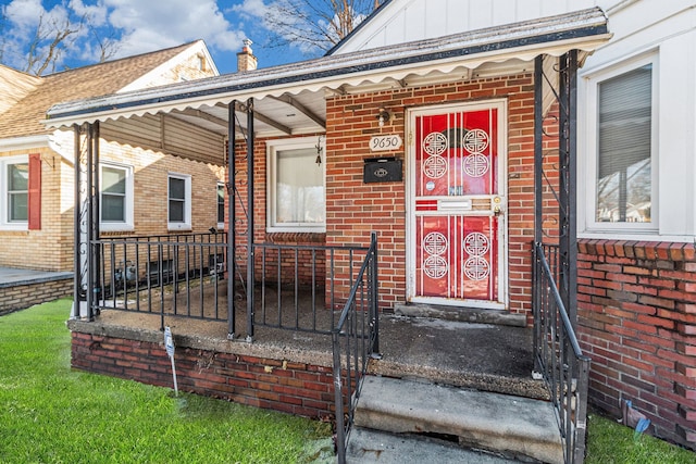 property entrance featuring brick siding and board and batten siding