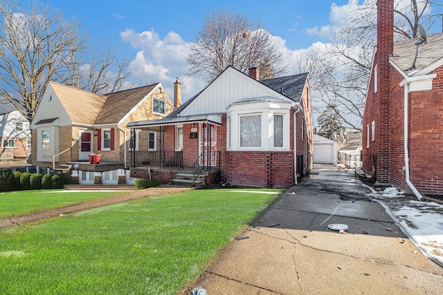 bungalow-style house with brick siding, a chimney, an outdoor structure, and a front lawn