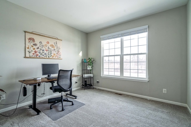 carpeted office featuring visible vents and baseboards