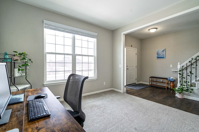 home office with baseboards, dark carpet, and dark wood-type flooring