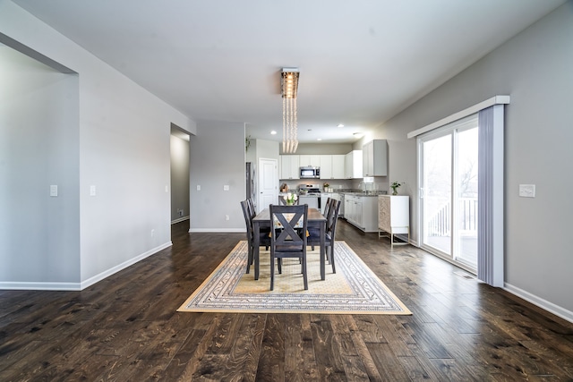 dining area with baseboards, dark wood-style flooring, and recessed lighting