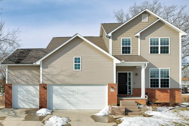 view of front of house with a garage, concrete driveway, brick siding, and a shingled roof