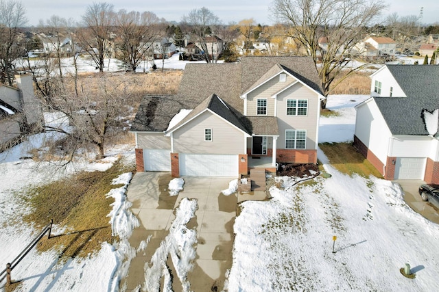 snowy aerial view with a residential view