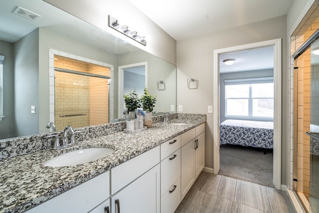 bathroom featuring connected bathroom, visible vents, a sink, and a tile shower