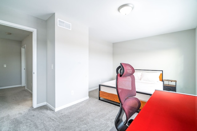 office featuring baseboards, visible vents, and light colored carpet