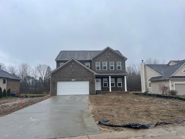 traditional-style home with concrete driveway, brick siding, and an attached garage