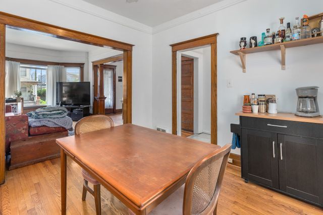 dining room featuring light wood-style flooring and crown molding