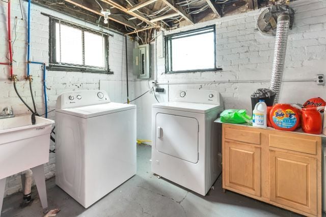 clothes washing area featuring plenty of natural light, independent washer and dryer, and electric panel