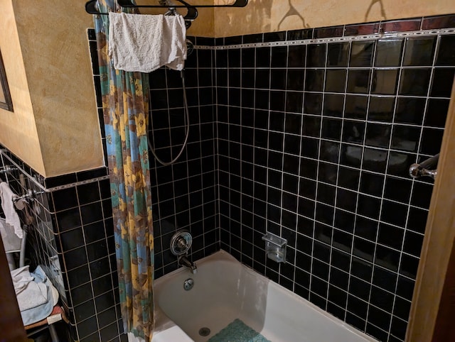 full bath with tile walls, a wainscoted wall, and shower / bathtub combination with curtain