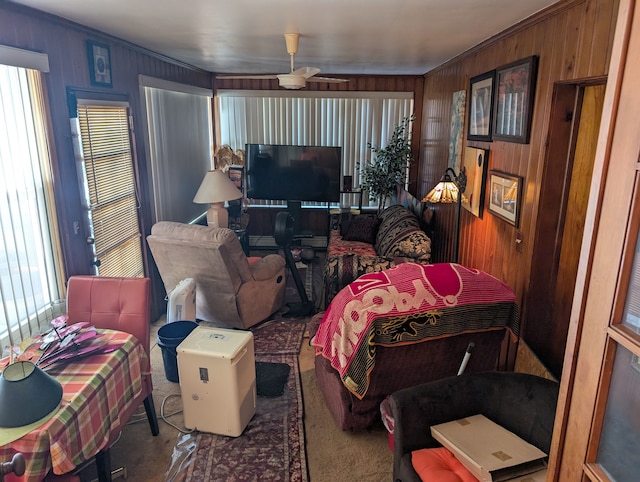 living room with wood walls and crown molding