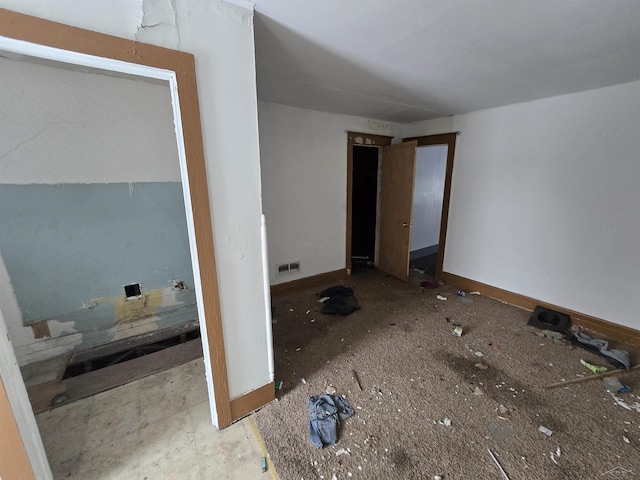 unfurnished bedroom with visible vents and baseboards