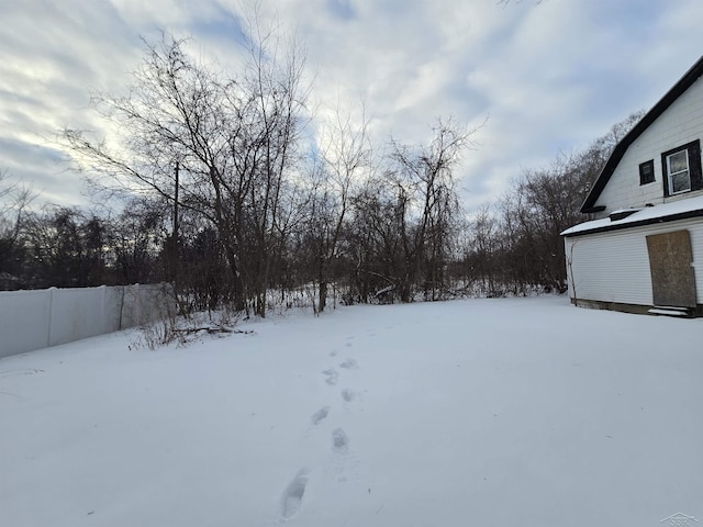 yard covered in snow with fence