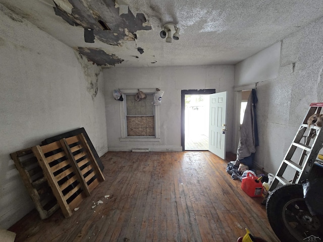 entryway with a textured ceiling and wood finished floors