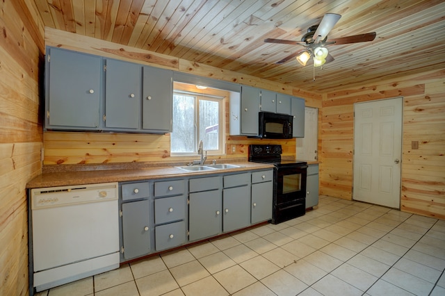 kitchen featuring wood ceiling, a sink, wood walls, and black appliances