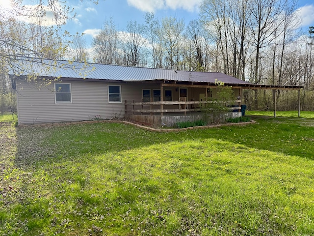 6619 M 18, Coleman, MI 48618 - rear view of property with a lawn, metal roof, and a carport