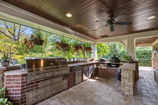 view of patio with ceiling fan, grilling area, an outdoor kitchen, and a sink