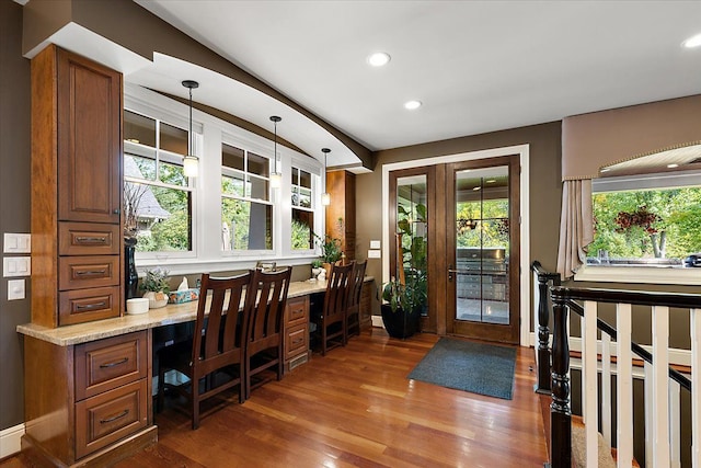 office area featuring french doors, dark wood finished floors, built in desk, recessed lighting, and baseboards