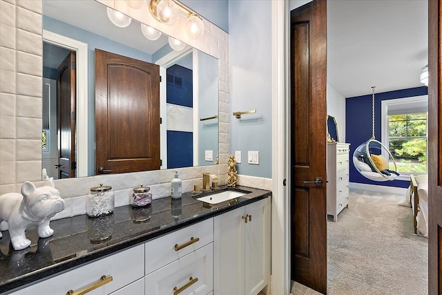 ensuite bathroom featuring ensuite bath and vanity