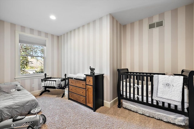 bedroom featuring recessed lighting, light colored carpet, visible vents, baseboards, and wallpapered walls