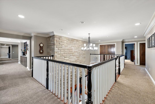 corridor with light carpet, baseboards, ornamental molding, a notable chandelier, and recessed lighting