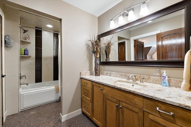 bathroom featuring baseboards, washtub / shower combination, vanity, and tile patterned floors