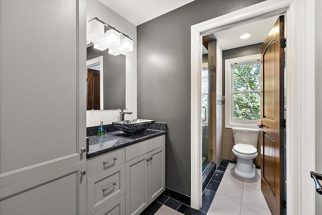 full bath with toilet, tile patterned flooring, a shower stall, and vanity